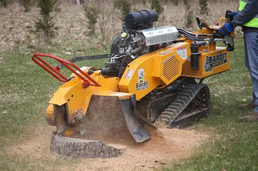 Bandit stump grinder actively grinding a stump on a job site